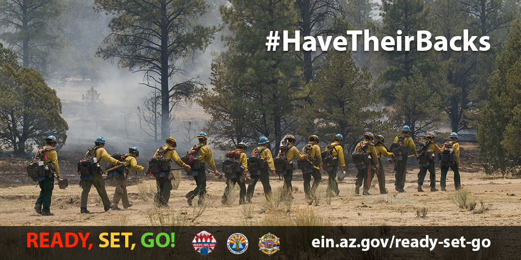 Image shows wildland firefighters walking in line