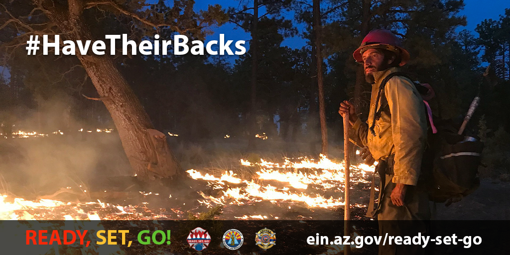 Image shows a wildland firefighter at night