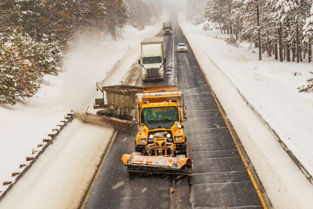Photo of an Arizona Department of Transportation snowplow clearing snow from a highway