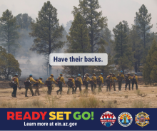 Photo of a line of wildland firefighters walking into the forest, equipped to fight a fire. In the foreground, words read “Have Their Backs.” For more information visit ein.az.gov/ready-set-go.